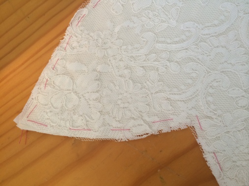 Basting the lace to the interfaced satin.